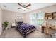 Cozy bedroom with a large window, carpet, and a ceiling fan at 7318 Lamplighter St, Spring Hill, FL 34606