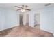 Spacious bedroom with carpet, ceiling fan, and ensuite bathroom and closet at 7318 Lamplighter St, Spring Hill, FL 34606