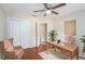 Bedroom with hardwood floors, a ceiling fan, and a desk area at 7318 Lamplighter St, Spring Hill, FL 34606