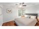 Bedroom featuring hardwood floors, neutral wall paint and natural light from a large window at 7318 Lamplighter St, Spring Hill, FL 34606