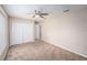 Bright bedroom with carpet, a ceiling fan, and a closet for storage at 7318 Lamplighter St, Spring Hill, FL 34606