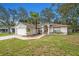 Single-story home with a landscaped yard, walkway to the front door, and attached garage at 7318 Lamplighter St, Spring Hill, FL 34606
