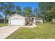 Charming single-story home featuring a manicured lawn, and a two-car garage at 7318 Lamplighter St, Spring Hill, FL 34606