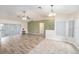 Bright living area featuring hardwood floors, sliding doors, and a ceiling fan at 7318 Lamplighter St, Spring Hill, FL 34606