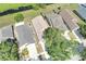 Aerial view showcasing the neighborhood's well-maintained homes, green spaces, and pond, offering a serene living environment at 7855 Bristol Park Dr., Apollo Beach, FL 33572