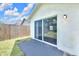 View of the backyard and fence through the sliding glass door at 7855 Bristol Park Dr., Apollo Beach, FL 33572