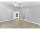 Primary bedroom with wood floors, ceiling fan, and an en suite bathroom at 7855 Bristol Park Dr., Apollo Beach, FL 33572
