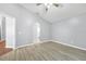 Bedroom with wood floors, ceiling fan, en suite bathroom, and walk in closet at 7855 Bristol Park Dr., Apollo Beach, FL 33572