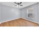 Bedroom with light grey walls, ceiling fan and hardwood flooring at 7855 Bristol Park Dr., Apollo Beach, FL 33572