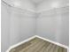 Walk-in closet with custom shelving and wood floors at 7855 Bristol Park Dr., Apollo Beach, FL 33572