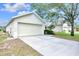 Single-story home with a two-car garage, mature landscaping, and a well-maintained lawn at 7855 Bristol Park Dr., Apollo Beach, FL 33572