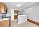 Bright kitchen featuring stainless steel appliances, light countertops, tiled floors and wood cabinets at 7855 Bristol Park Dr., Apollo Beach, FL 33572