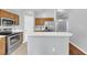 Modern kitchen with stainless steel appliances, wood cabinets, and stylish countertops at 7855 Bristol Park Dr., Apollo Beach, FL 33572
