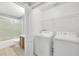 Laundry room featuring a washer and dryer, with an adjacent bathroom at 7855 Bristol Park Dr., Apollo Beach, FL 33572