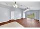 Living room with wood floors, gray walls, and sliding glass doors to the backyard at 7855 Bristol Park Dr., Apollo Beach, FL 33572