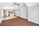 Living room featuring wood flooring and an open view of the kitchen at 7855 Bristol Park Dr., Apollo Beach, FL 33572
