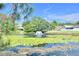 Scenic pond with a fountain, surrounded by lush greenery and lily pads at 7855 Bristol Park Dr., Apollo Beach, FL 33572