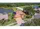 Beautiful single-story home with a tile roof, two car garage, fountain, and lake view in a desirable neighborhood at 800 Belted Kingfisher S Dr, Palm Harbor, FL 34683