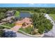 Beautiful single-story home with a tile roof, two car garage, fountain, and lake view in a desirable neighborhood at 800 Belted Kingfisher S Dr, Palm Harbor, FL 34683