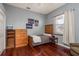 Cozy bedroom featuring hardwood floors, a closet, and a window with natural light at 800 Belted Kingfisher S Dr, Palm Harbor, FL 34683