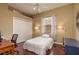 Comfortable bedroom with a ceiling fan, closet, and a large window with blinds at 800 Belted Kingfisher S Dr, Palm Harbor, FL 34683