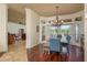 Stylish dining area with hardwood floors, a modern chandelier and a cozy seating area with views to the backyard at 800 Belted Kingfisher S Dr, Palm Harbor, FL 34683