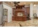 Kitchen featuring dark wood cabinets, granite countertops, stainless steel appliances, and tiled backsplash at 800 Belted Kingfisher S Dr, Palm Harbor, FL 34683