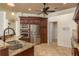 Kitchen featuring stainless steel appliances, granite countertops, dark wood cabinets, and a double sink at 800 Belted Kingfisher S Dr, Palm Harbor, FL 34683