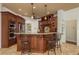 Kitchen with dark wood cabinets, granite countertops, stainless steel appliances, and an island with bar seating at 800 Belted Kingfisher S Dr, Palm Harbor, FL 34683