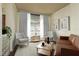 Bright living room with hardwood floors, two armchairs, sofa, and plenty of natural light with views to the yard at 800 Belted Kingfisher S Dr, Palm Harbor, FL 34683
