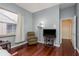 Comfortable living room with hardwood floors, a large window, and a tv at 800 Belted Kingfisher S Dr, Palm Harbor, FL 34683