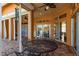 Outdoor patio seating on brick pavers with a ceiling fan and access to a screened-in lanai at 800 Belted Kingfisher S Dr, Palm Harbor, FL 34683