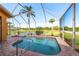 Screened in pool and spa with brick pavers and a view of the lake at 800 Belted Kingfisher S Dr, Palm Harbor, FL 34683