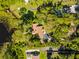 Aerial view of home nestled among trees with lake access at 8011 N Mobley Rd, Odessa, FL 33556
