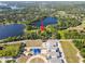 Aerial view of a home near a lake and a school with sports facilities at 8011 N Mobley Rd, Odessa, FL 33556