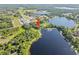 Stunning aerial view showcases the property's prime waterfront location on a beautiful lake at 8011 N Mobley Rd, Odessa, FL 33556