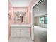 Bright bathroom features a large mirror and vanity with storage and counter space at 8011 N Mobley Rd, Odessa, FL 33556