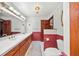 Traditional bathroom featuring double vanity, lighting fixture, and accent wall at 8011 N Mobley Rd, Odessa, FL 33556