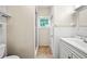 Bathroom with white tiled walls, walk-in shower, window, and vanity sink at 8011 N Mobley Rd, Odessa, FL 33556