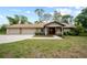 Charming single-story home boasts a three-car garage, stone accents, and a well-manicured lawn at 8011 N Mobley Rd, Odessa, FL 33556