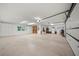 Spacious garage featuring epoxy flooring, ample storage cabinets, and a convenient tool organization board at 8011 N Mobley Rd, Odessa, FL 33556