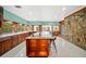 Bright eat-in kitchen features a stone accent wall and a marble island with bar stool seating at 8011 N Mobley Rd, Odessa, FL 33556