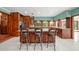 Bright eat-in kitchen features a center island with bar stool seating, tile floors, and wood cabinets at 8011 N Mobley Rd, Odessa, FL 33556