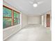 Bright open living room features a large window and neutral color palette at 8011 N Mobley Rd, Odessa, FL 33556