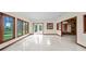 Open living room with tile floors, lots of windows, and glass doors to outdoor patio at 8011 N Mobley Rd, Odessa, FL 33556