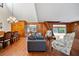 Spacious living room features hardwood floors, wood paneling, and a cozy seating area at 8011 N Mobley Rd, Odessa, FL 33556