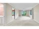 Spacious living room with a ceiling fan and glass doors leading to an outdoor patio at 8011 N Mobley Rd, Odessa, FL 33556