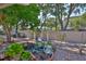 Tranquil backyard with a serene pond, lush plants, brick pathway, and a cozy seating area at 8916 Southbay Dr, Tampa, FL 33615