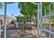 Relaxing backyard oasis featuring a lush garden, statues, and a charming white pergola at 8916 Southbay Dr, Tampa, FL 33615