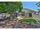 Lush backyard featuring manicured plants, brick paths, and a screened lanai at 8916 Southbay Dr, Tampa, FL 33615
